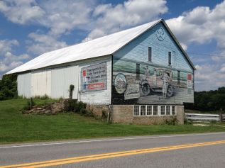 This cool mural was located on a barn across the street from the Bison Corral Gift Shop in Schellsburg, PA. Times Square in the east, Golden Gate in the west, for cross-country travel, it was the best. Lincolnway! (Photo by Jennifer Sopko)
